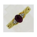 A 9ct gold ring set with six small diamonds & ruby