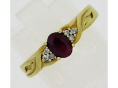 A 9ct gold ring set with six small diamonds & ruby