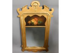 An antique gilt framed mirror with still life pain