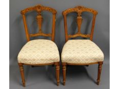 A pair of walnut bedroom chairs, 34in high to back