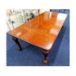 A Victorian extending mahogany dining table with b