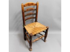 A 19thC. rush seated oak ladderback chair, 36.5in