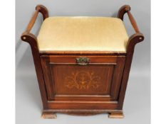 An Edwardian mahogany piano stool with drop down m