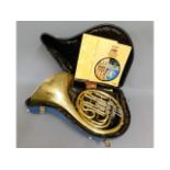 A cased brass Paxman Studenti model French horn