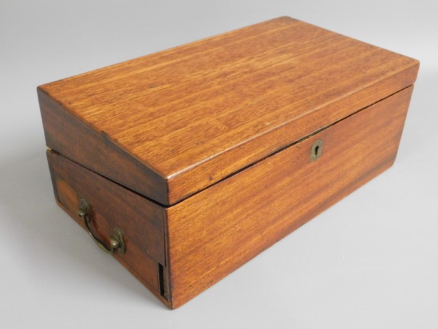 A 19thC. mahogany writing slope with brass fitting