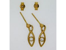 A pair of 9ct gold earrings set with 0.1ct of diam