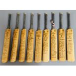 A quantity of nine miniature tour team cricket bat