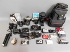 A quantity of cameras & equipment: Canon Sureshot,