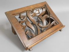 An oak book stand with carved initials, 14in wide