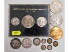 A US dollar set, a 1923 silver dollar, a £5 crown