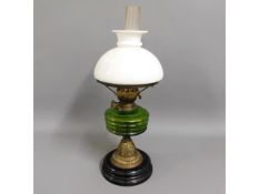 A c.1900 oil lamp with shade, 22in tall