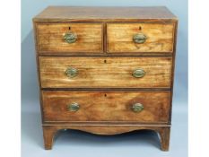 A compact George III walnut chest of four drawers