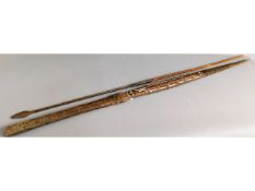 Two African spears, one wooden with carving, the o