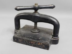 An extremely heavy, antique cast iron book press,