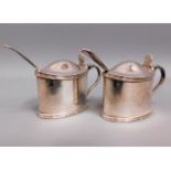 A pair of silver plated Walker & Hall mustard pots