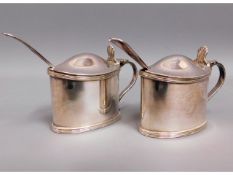 A pair of silver plated Walker & Hall mustard pots