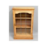 An antique pine bookcase with shelves & leaded gla
