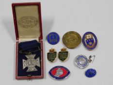 A hallmarked silver & enamel nurses badge, a NHCIF