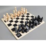 A carved stone African chess set with marble type