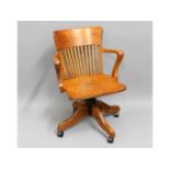 An antique oak captains chair with later added whe
