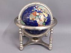 A small mineral globe, compass underneath, lacking