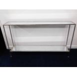 An Oka chrome console table with distressed mirror