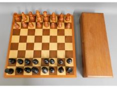 A carved wood chess set, King 4.5in tall, board 17