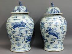 A large decorative pair of Chinese lidded urns wit