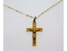 An 18in long 9ct gold chain with crucifix, 24mm hi