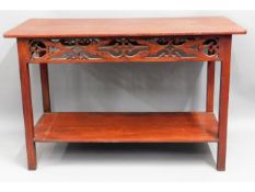 A stained console table with carved decor, believe