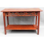 A stained console table with carved decor, believe