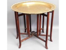 An antique Chinese hardwood folding table with hea