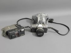 A Olympus OM30 35mm film camera twinned with an Ol