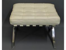 A Zebi white leather & chrome footstool, 23.5in wi