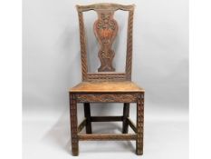 A 19thC. oak hall chair with carved decor, 39.5in