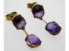 A pair of 9ct gold drop earrings set with amethyst