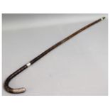 A gents cane bound walking stick with silver mount