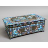 An Oriental box with applied enamel decor, two cha