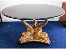 A Brights of Nettlebed Regency reproduction marble table with gilded Dolphin base, 47in diameter x 3