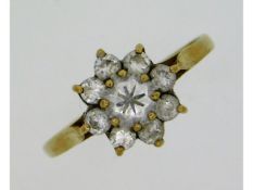 A 9ct gold ring set with paste stones, mark rubbed