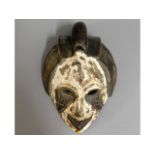 An African tribal art carved mask, 11in high x 8in