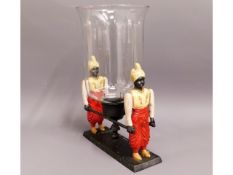 A figurative spelter style candle holder with glas