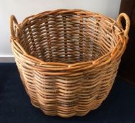 A large wicker log basket, 25.5in wide x 20.25in h