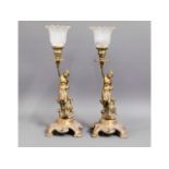 Two matching brass figurative candle holders with