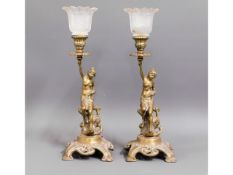 Two matching brass figurative candle holders with