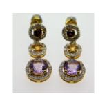 A pair of 9ct gold drop earrings set with garnet,