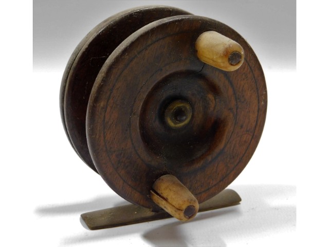 A vintage wooden & brass fishing reel, split to on