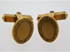 A pair of gents yellow metal cufflinks with chased