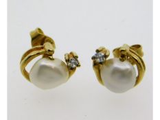 A pair of 9ct gold earrings set with diamond & bar