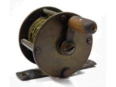 A vintage brass fishing reel, 38mm diameter